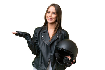 Wall Mural - Young pretty caucasian woman with a motorcycle helmet over isolated background extending hands to the side for inviting to come