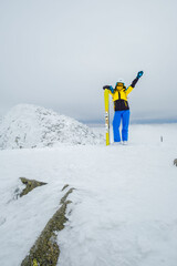 Poster - woman skier posing on the top of snowed mountain