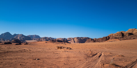 Wadi Rum, Jordan. A beautiful vibrant blue and orange view, Arabian desert, a dystopian martian landscape with unique rock formations and dunes. Backdrop for graphic resource or copy space no people