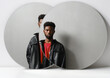 © Clique Images - Horizontal contemporary creative studio two mirrors reflection portrait of stylish young Black man wearing leather jacket looking at camera