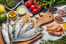 Fresh Fish Food Background. Different Seafood, Shrimps And Red Caviar. Fish For Cooking With Herbs, Vegetables And Spices Isolated On White Background. Raw Meats Panorama Banner.