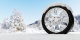 Single tire covered with snow on winter landscape background, winter tire concept, copy space