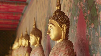 Wall Mural - Closeup of golden statues in a Buddhist temple