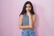 © Krakenimages.com - Young teenager girl wearing casual striped t shirt looking confident at the camera with smile with crossed arms and hand raised on chin. thinking positive.