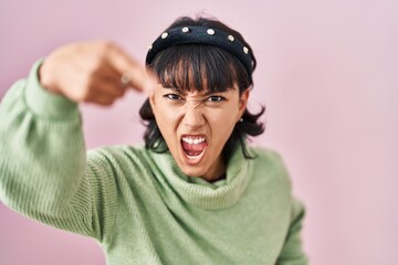 Poster - Young beautiful woman standing over pink background pointing displeased and frustrated to the camera, angry and furious with you