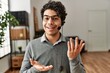 © Krakenimages.com - Young hispanic call center agent man smiling happy working at the office.