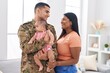© Krakenimages.com - Hispanic family army soldier hugging each other at home
