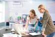 © Pixel-Shot - Double exposure of graphs and beautiful businesswoman with her colleague discussing issue in office