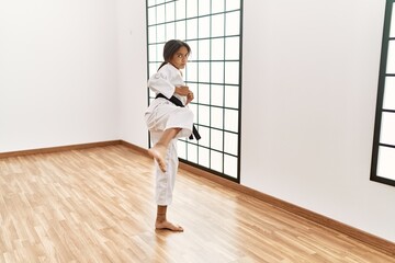 Wall Mural - African american girl wearing kimono training karate at sport center