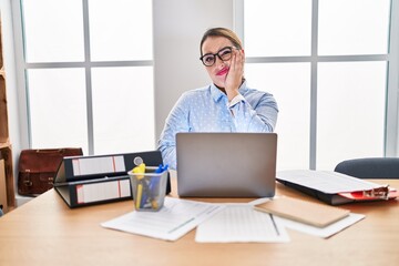 Poster - Young hispanic woman working at the office wearing glasses thinking looking tired and bored with depression problems with crossed arms.