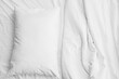 © Pixel-Shot - Soft crumpled bedding and pillow, closeup