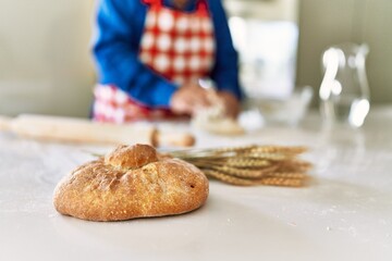 Poster - Senior man keading dough with hands at kitchen