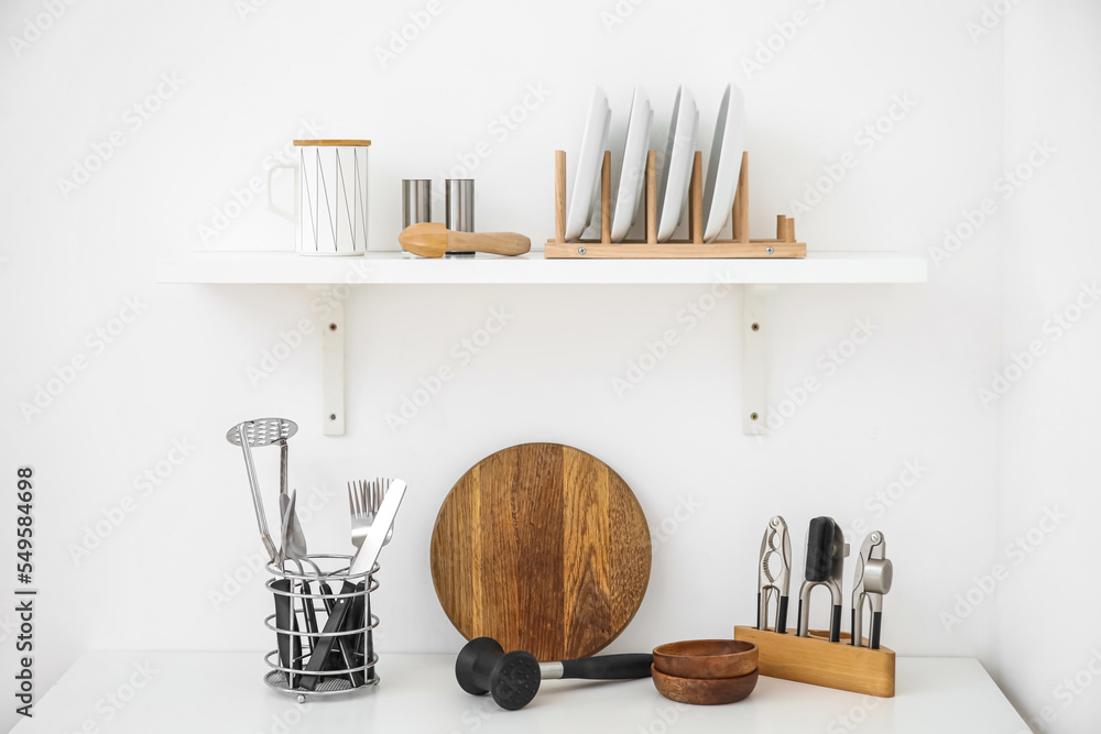 Different kitchen utensils on light background