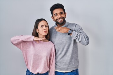 Sticker - Young hispanic couple standing together cutting throat with hand as knife, threaten aggression with furious violence