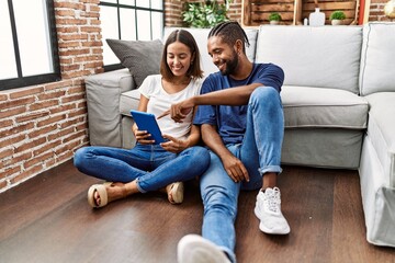 Sticker - Man and woman couple smiling confident using touchpad at home