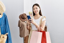 Young Asian Woman Going Shopping Using Smartphone At Retail Shop