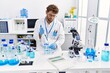 © Krakenimages.com - Young hispanic man wearing scientist uniform working at laboratory