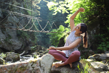 Sticker - Happy young woman doing morning exercise in mountains