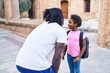 © Krakenimages.com - Father and daughter standing together speaking at school