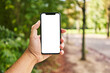 © Krakenimages.com - Man holding smartphone showing white blank screen at park