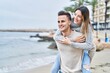 © Krakenimages.com - Man and woman couple hugging each other holding on back at seaside