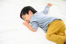 Cute Asian Toddler Who Ran Out Of Strength And Fell Asleep.