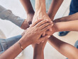 © Deen Jacobs/peopleimages.com - Teamwork, hands together and team building of business people with support, collaboration or startup mission for company background. Hand stack sign, community and solidarity group in diversity above