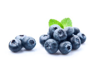 Wall Mural - Blueberries with mint leaves closeup on white backgrounds.