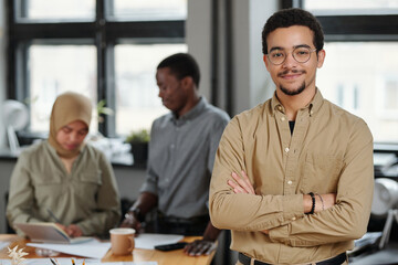 Aufkleber - Young successful chief executive officer in smart beige casualwear keeping his arms crossed on chest while standing in front of camera