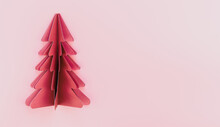A Pink Paper Origami Christmas Tree On Pink Background Isolated, Copy Space.