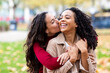 © Westend61 - Woman kissing friend in park