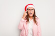 © Asier - Business caucasian woman wearing a christmas hat isolated on white background showing a disappointment gesture with forefinger.