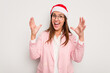 © Asier - Business caucasian woman wearing a christmas hat isolated on white background receiving a pleasant surprise, excited and raising hands.
