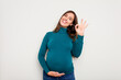 © Asier - Pregnant caucasian woman isolated on white background cheerful and confident showing ok gesture.