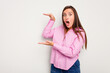© Asier - Young caucasian cute woman isolated on white background shocked and amazed holding a copy space between hands.