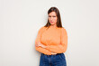 © Asier - Young caucasian cute woman isolated on white background frowning face in displeasure, keeps arms folded.