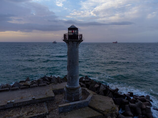 Wall Mural - flying around the lighthouse on a drone early in the morning at sunrise