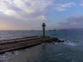 Wall Mural - flying around the lighthouse on a drone early in the morning at sunrise