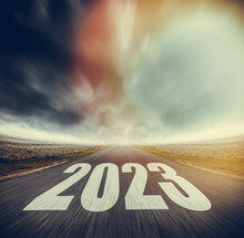 2023 Written On Highway Road In The Middle Of Asphalt Road And Dark Cloudy Sky. Future Vision 2023