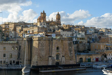 The Sheer Bastion In The Fortified City Maltese City Of Senglea With Moored Sail Boats In Dockyard Creek.