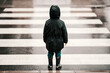 © Dusan Petkovic - Back view of a little boy in raincoat and boots standing on the crosswalk on rainy day.