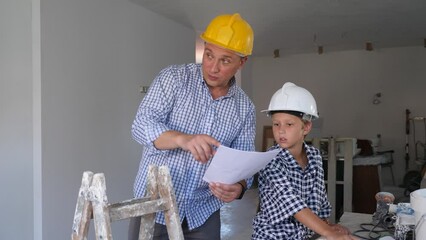 Wall Mural - Portrait of positive man showing blueprints to son, gesturing and discussing renovating of new home