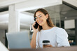 © S Fanti/peopleimages.com - Coffee, laptop or business woman on phone call for communication, contact us or networking in office. Smile, happy or employee with success business planning, telemarketing or schedule on technology