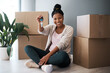 Boxes, black woman and homeowner with keys, to new home and happiness in home. Property, African American female and lady moving into house, happy and content with apartment, excited and portrait.