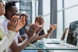 © Katsiaryna - Multi ethnic business group greets somebody with clapping and smiling