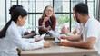 © Katsiaryna - group of diverse business people sitting together at a table