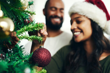 Canvas Print - Christmas, decorating tree and happy black couple celebrate holiday season with love, happiness and festive bonding. Black woman, man smile together and enjoy decorate Christmas tree in living room