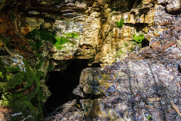 Canvas Print - Rock face with a cave