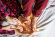 © Olha Tsiplyar - Family with children resting in bed. Christmas lights. Flat lay. Beautiful background.
