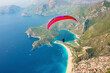 © AmazingAerialAgency - Aerial view of paraglider flying above Belcekiz Beach, Oludeniz, Fethiye, Turkey.